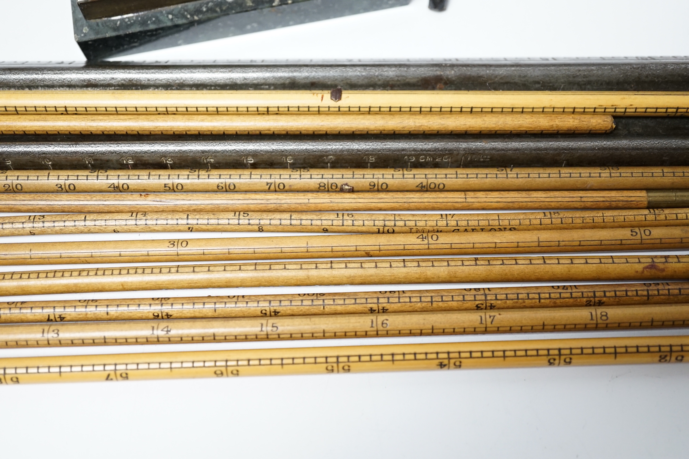 A group of desk top accessories including rulers, weights, a perpetual calendar etc.